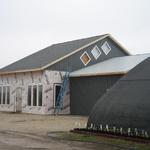 East side of upper center building siding completed around the diamond shaped windows.4/11/13