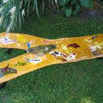 Hedge wood bench with inlay of Koi fish.  Custom designed and made steel legs.