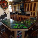 Kitchen designed and custom built by Chuck Kershner. Bar top and glass panel in front of bar, designed and created by Sue Kershner.